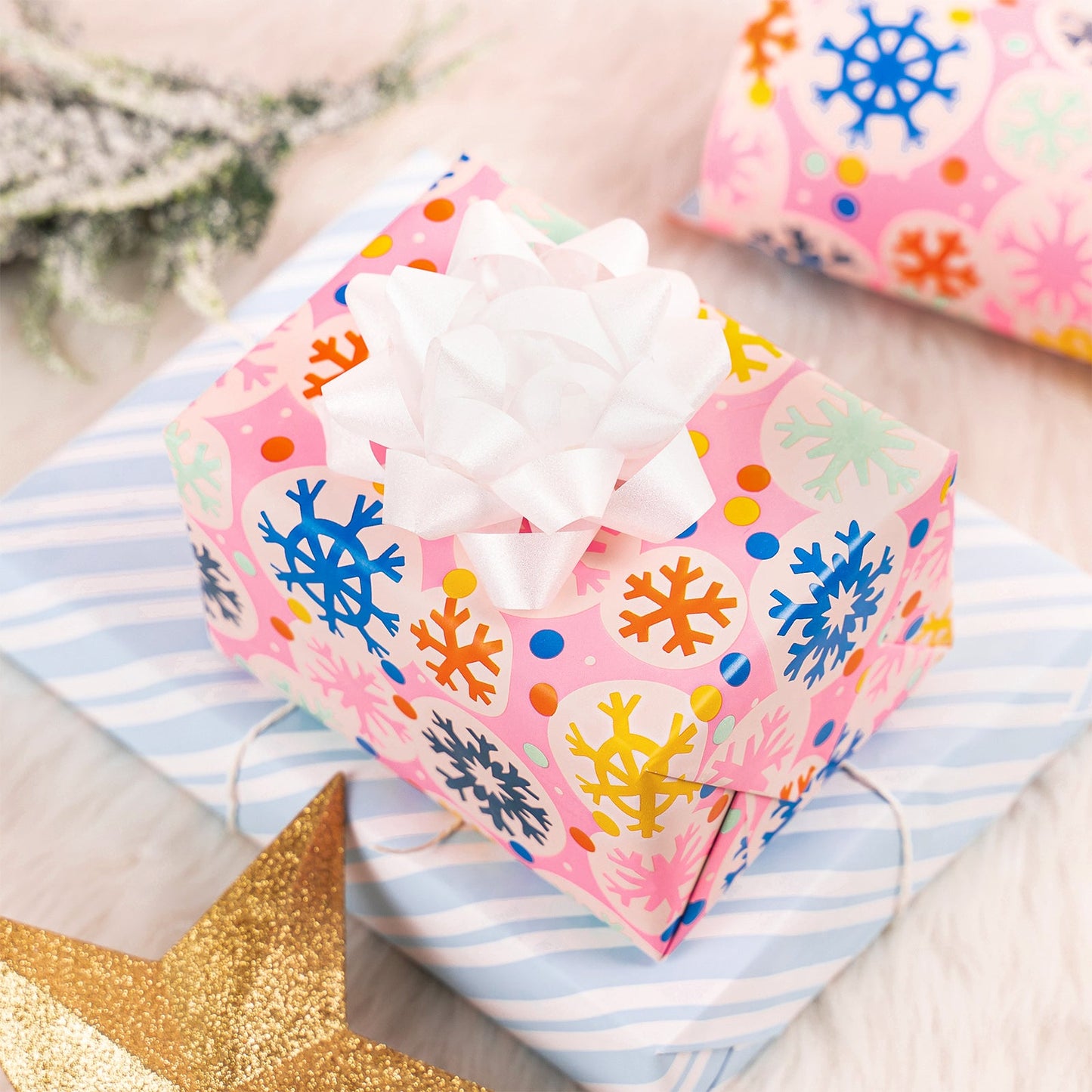Pink Snowflake Christmas Wrapping Paper Roll with Blue & White Diagonal Stripes on The Back